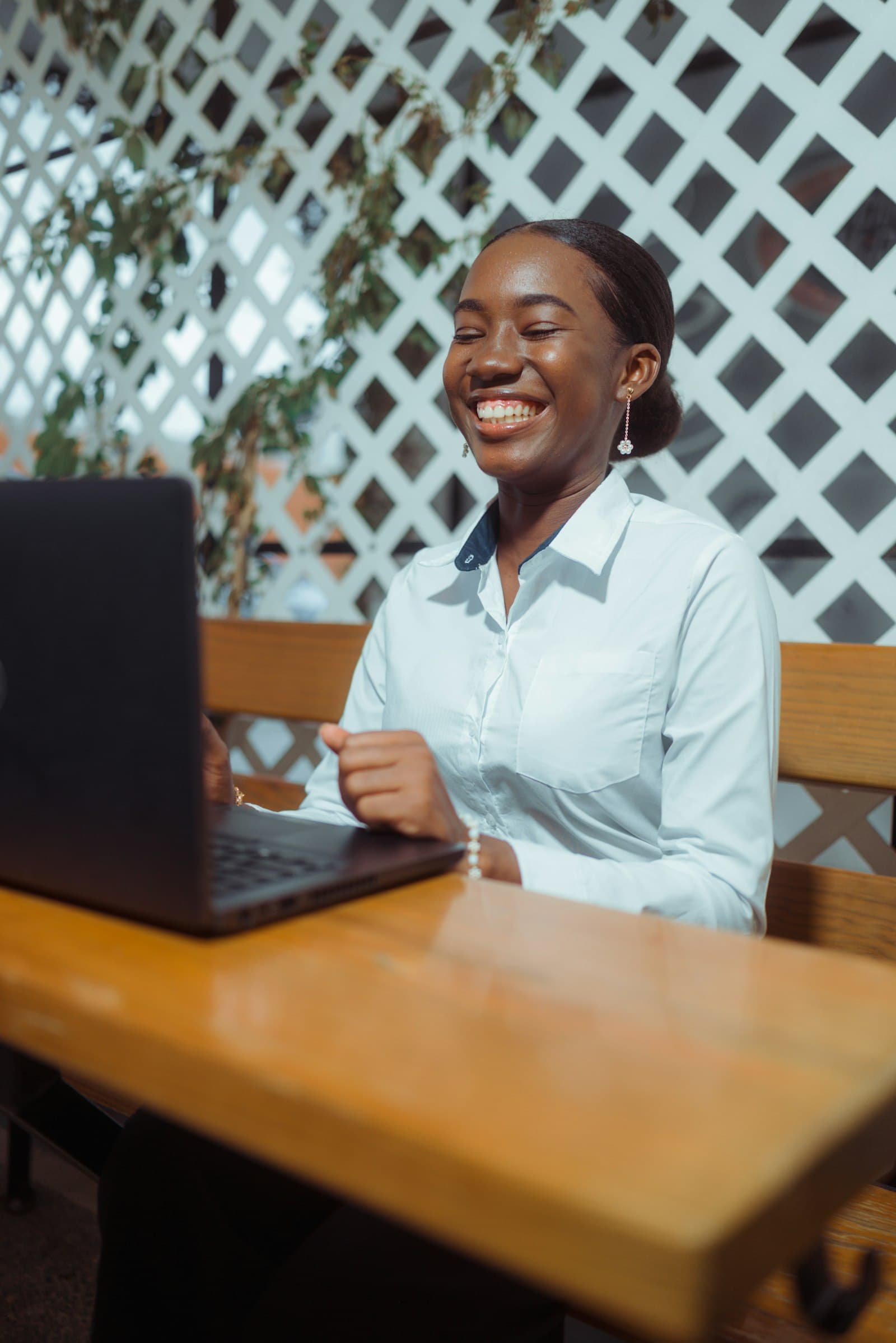 Young professional woman smiling at her laptop